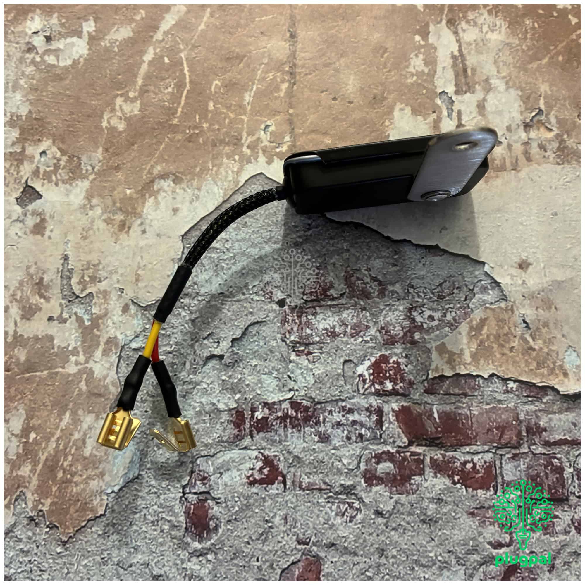 Ford 5V solid state voltage stabiliser with bracket, designed for automotive electrical systems, featuring a compact black casing and connecting wires with gold-plated connectors.