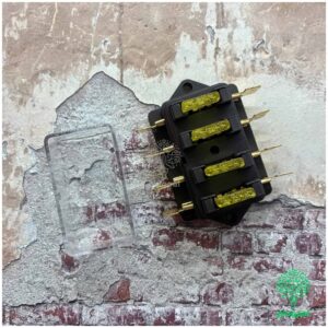 Close-up of a blade fuse box with four yellow LED fuses and metal prongs, used in automotive electrical systems.