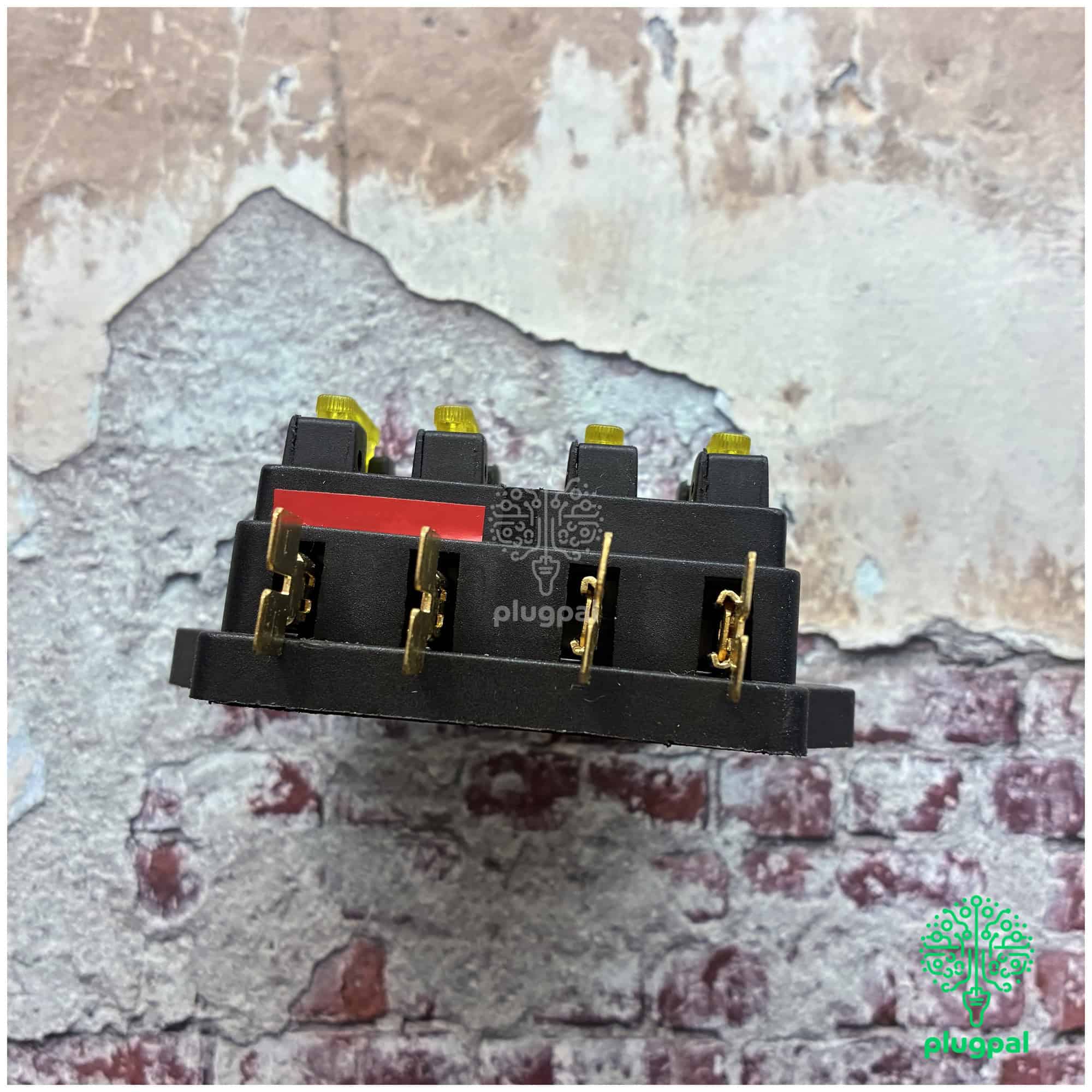 Close-up of MG blade fuse box with multiple fuses on a textured wall background, suitable for automotive electrical systems.