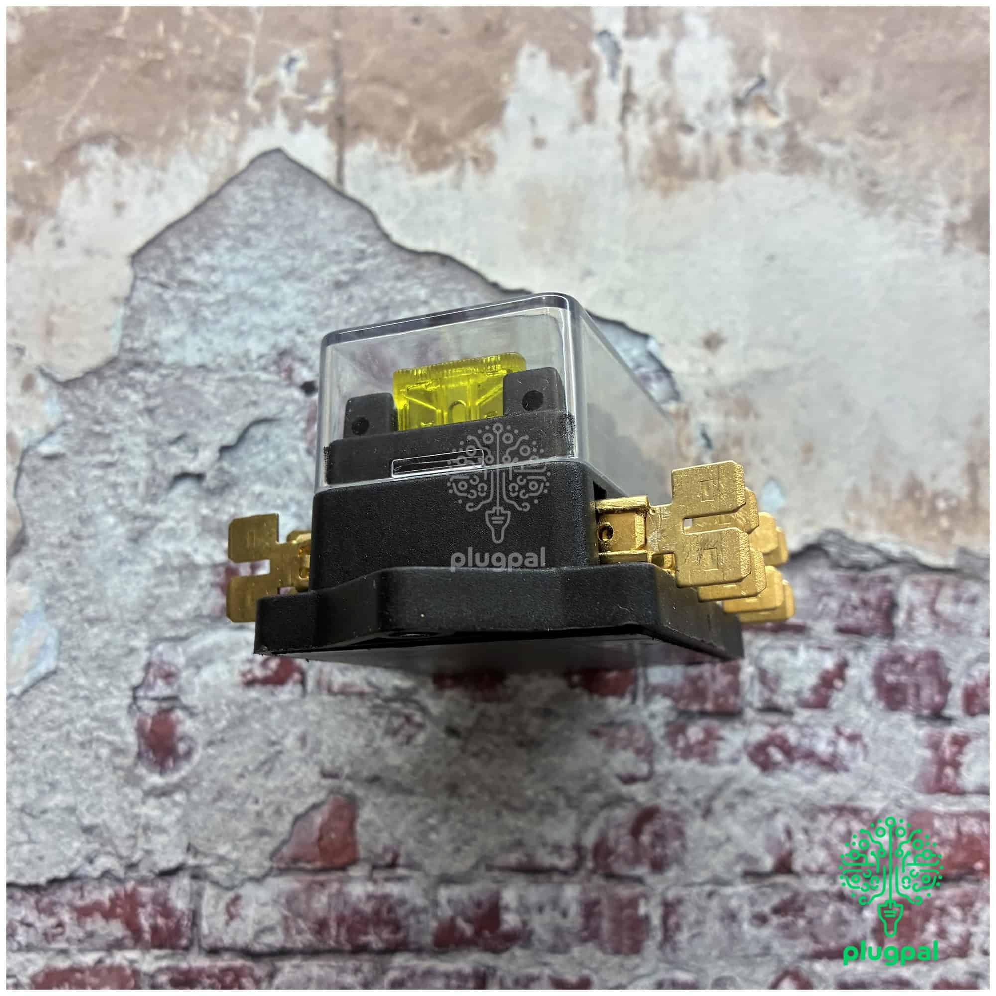 Close-up of MG Blade Fuse Box with transparent cover and yellow fuse, suitable for automotive electrical systems.
